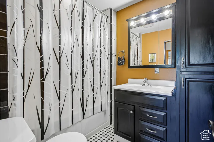 Black and white tile flooring complemented by dark cabinetry