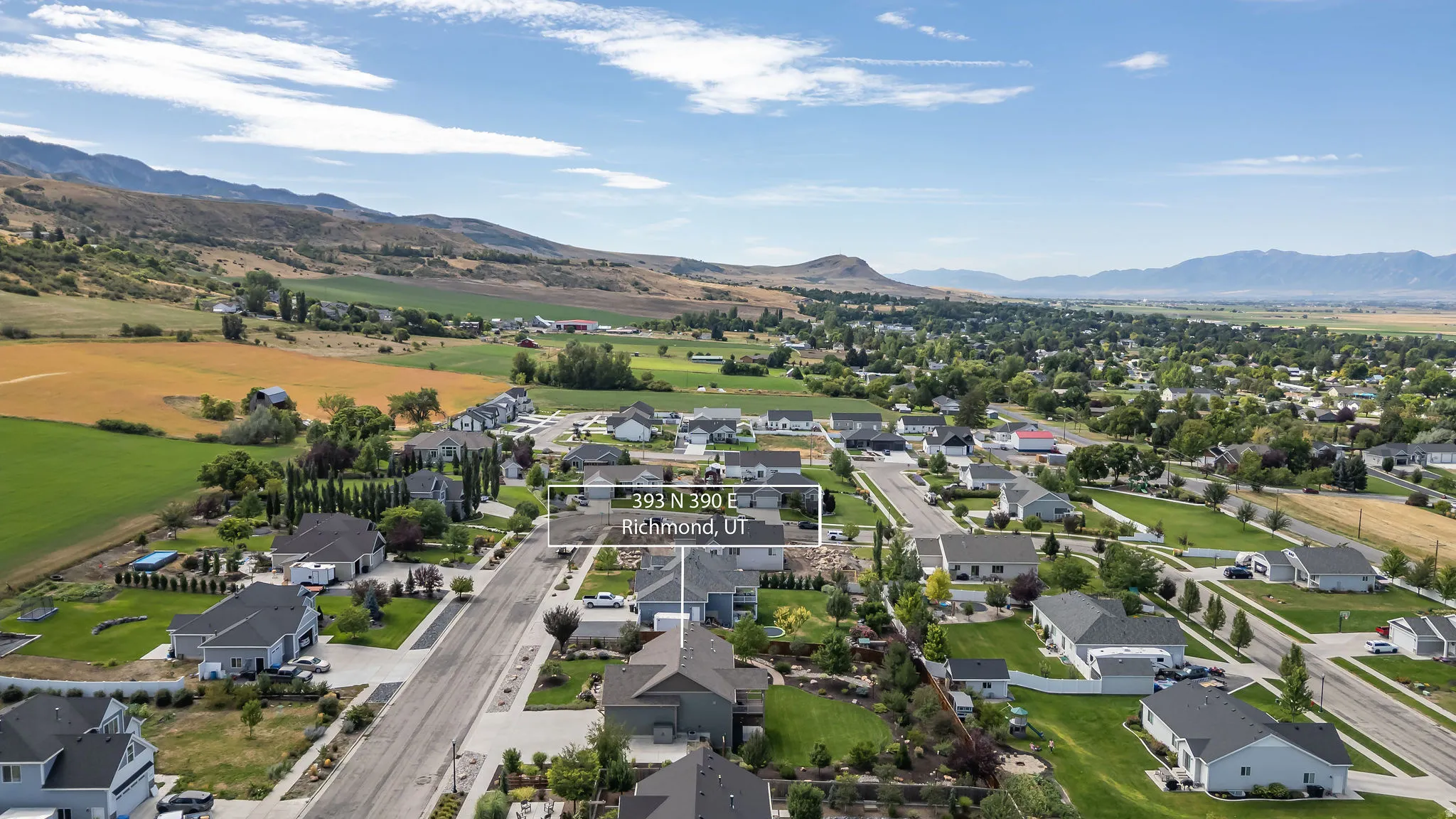 Rural residential setting with mountainous backdrop