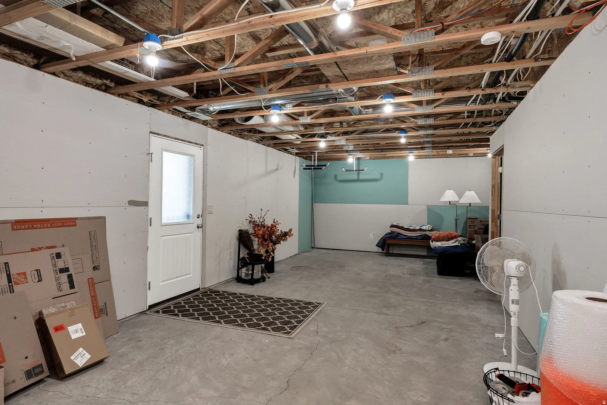 Exposed wood joist ceiling with visible electrical conduit