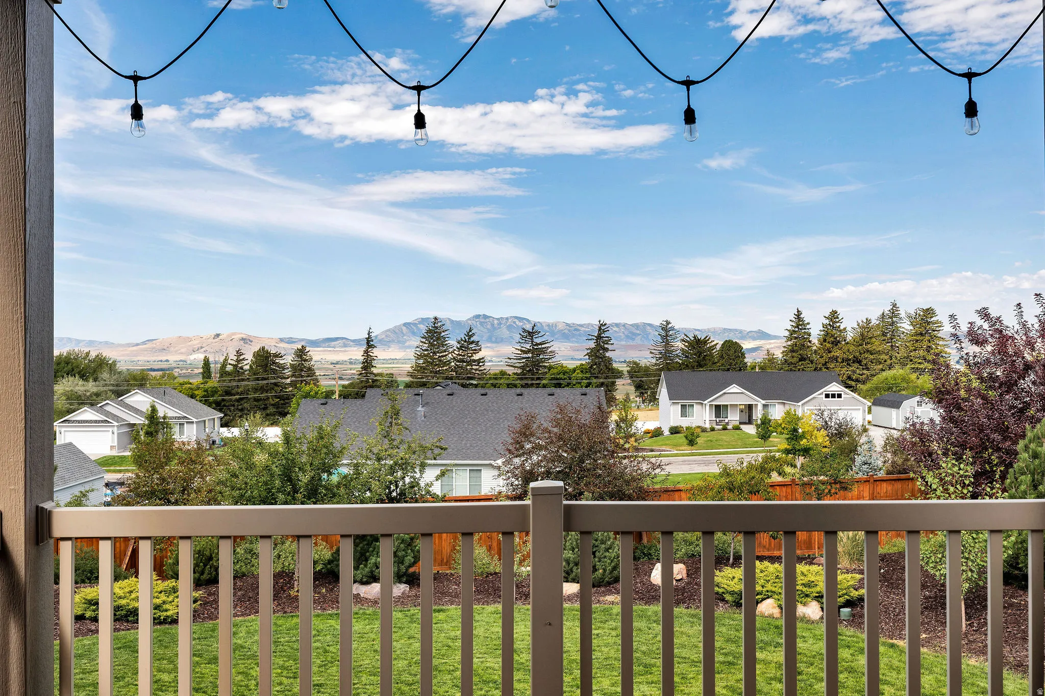 Covered deck off dining room overlooking a landscaped backyard