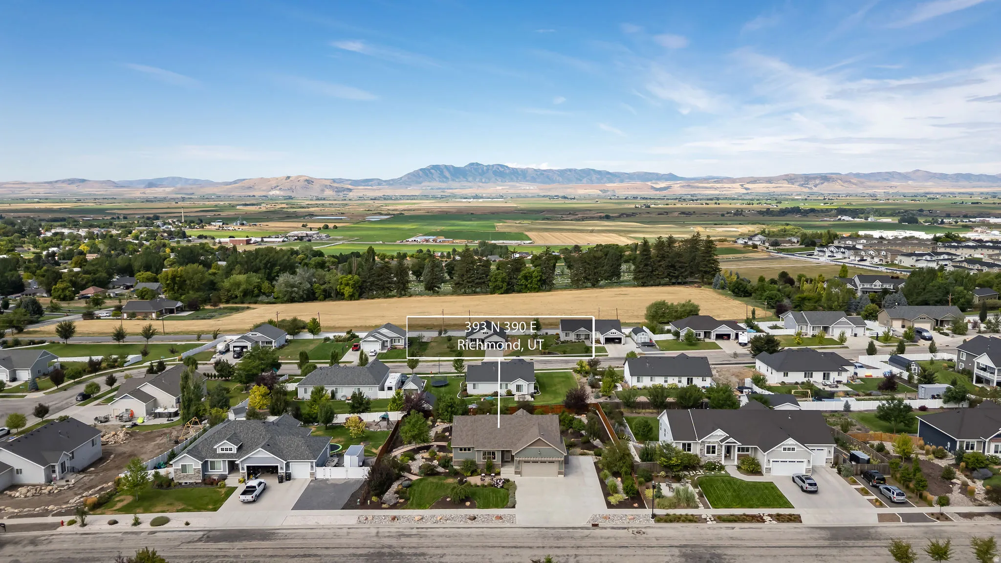 Aerial perspective showcasing expansive surrounding landscape and residential neighborhood