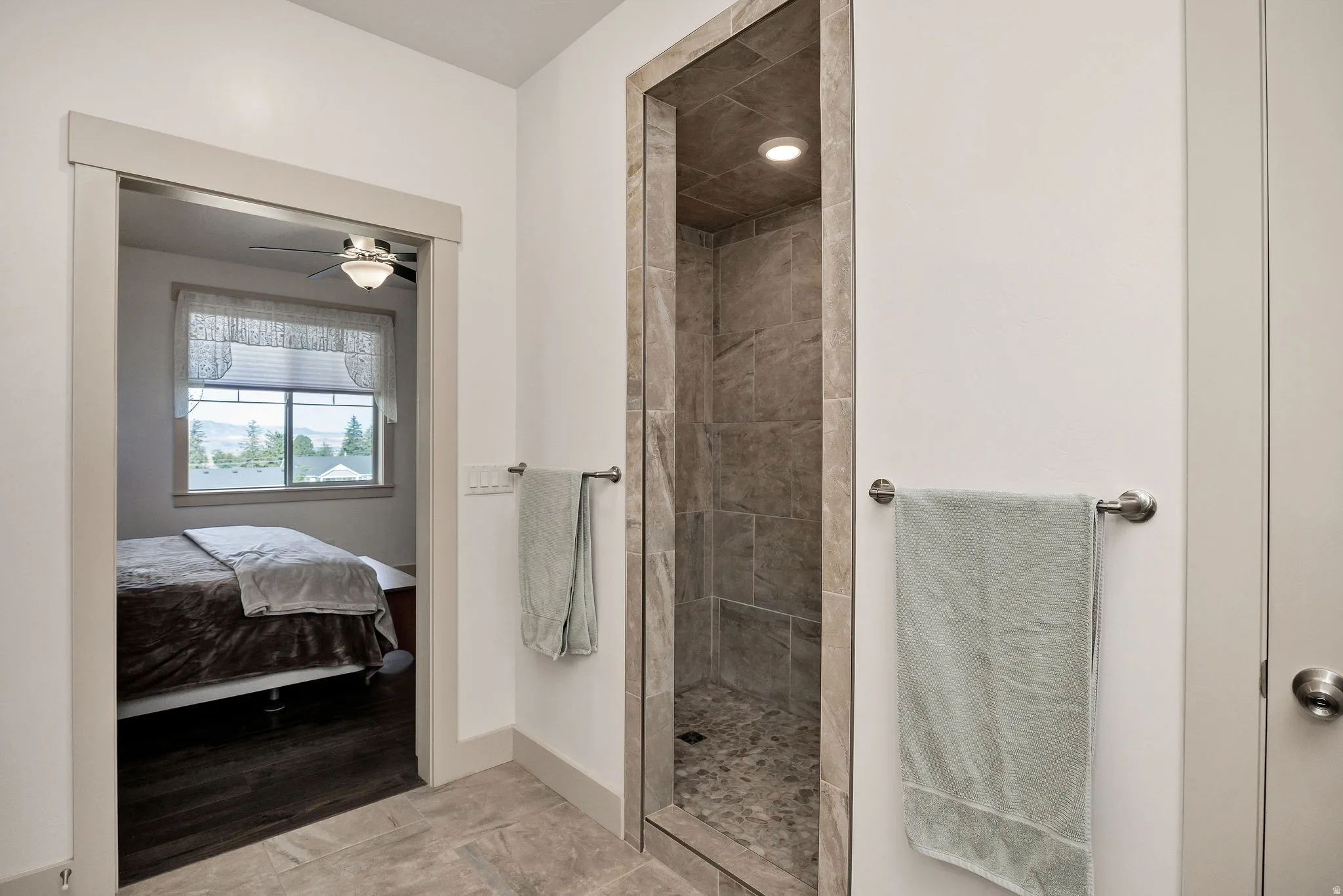 Walk-in shower with tiled surround and river rock base