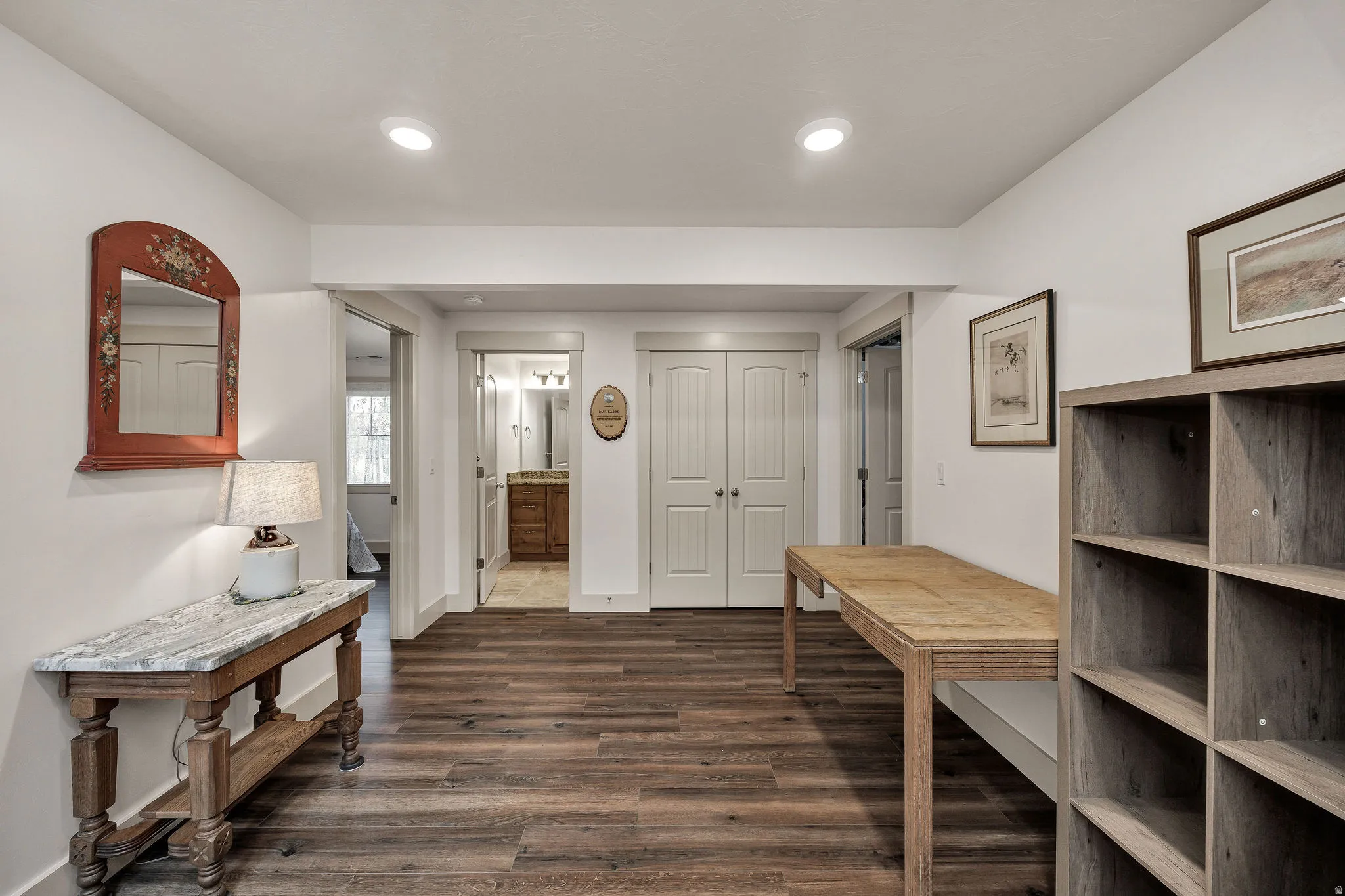 Wood-finish flooring, recessed ceiling lighting, and white walls