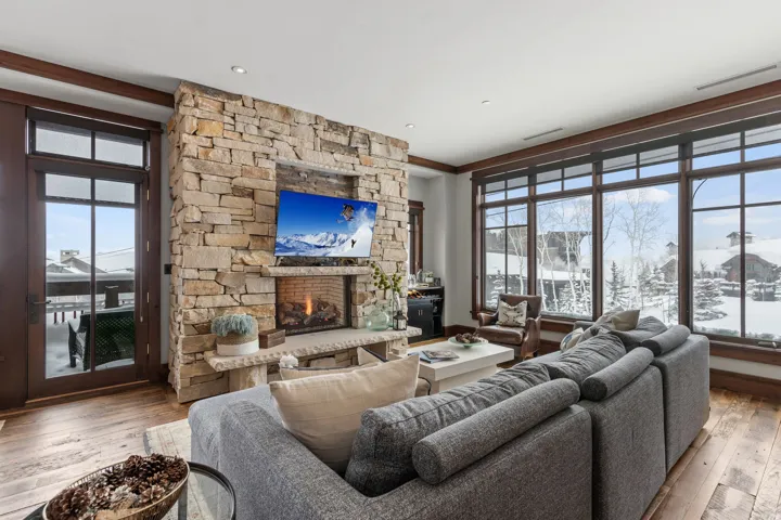 Stone-clad fireplace with a built-in media niche