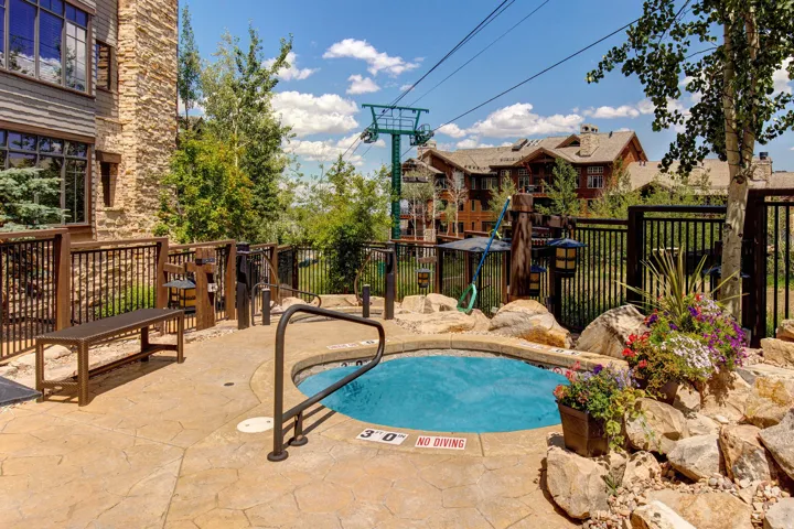 Outdoor spa with surrounding flagstone patio and natural rock landscaping