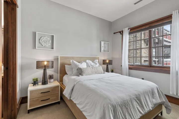 Neutral wall color, wood-finish flooring, wood-framed window, and window trim
