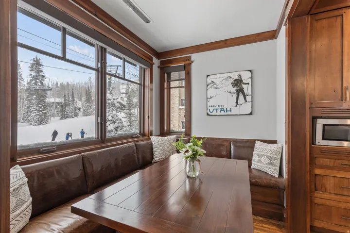 Built-in banquette seating with a dark wood-finish table and rich wood-tone trim