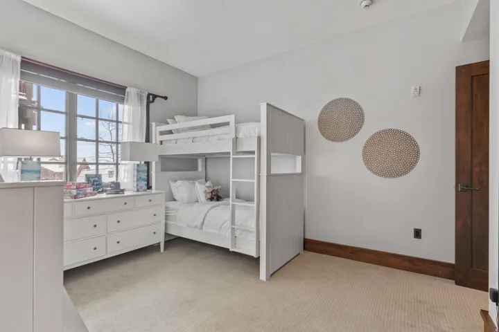 Carpeted flooring, multi-pane window, solid core door, and wood trim