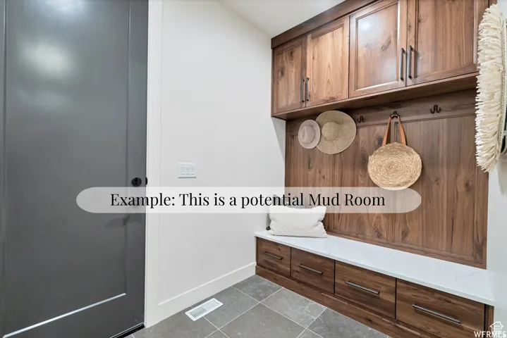 Built-in cabinetry with wood-finish panels, integrated bench seating, solid surface countertop, and multiple storage drawers
