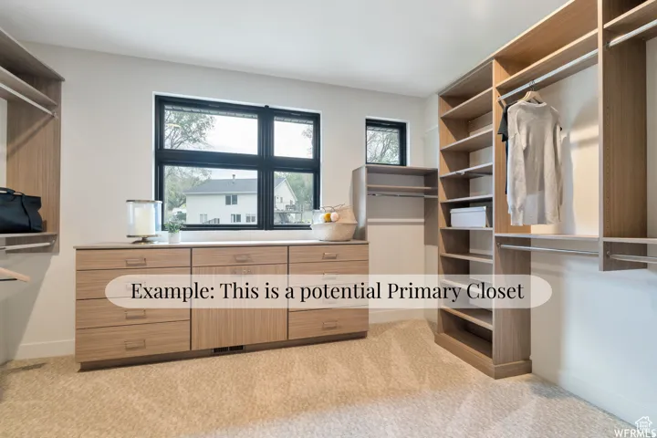Built-in wood-finish cabinetry, extensive shelving, integrated clothing rods, transom windows, and neutral carpeting