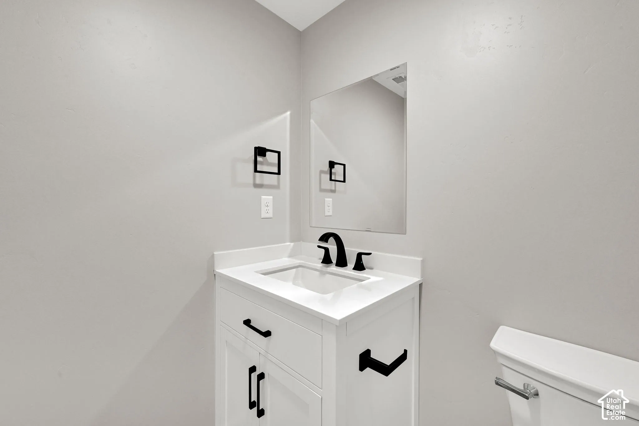 Powder room is conveniently located near the great room.