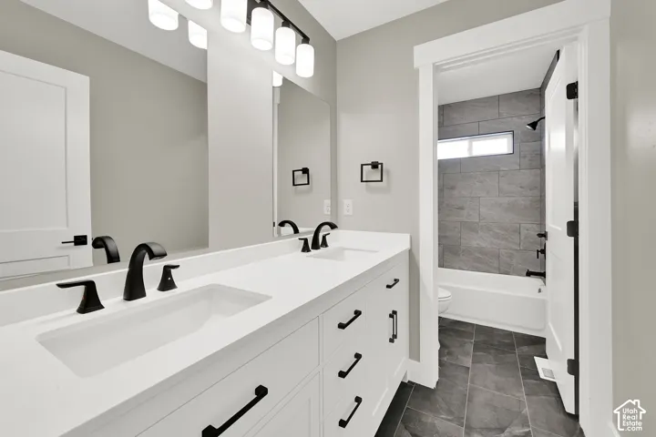 Large vanity with double sinks and a private tub/shower, offers plenty of space.