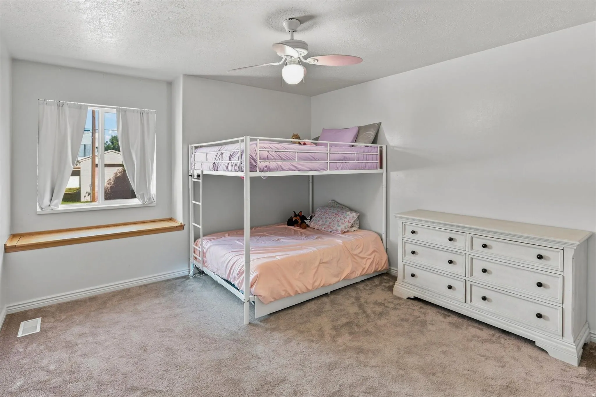 Bright room with a window featuring a wood-finish window seat