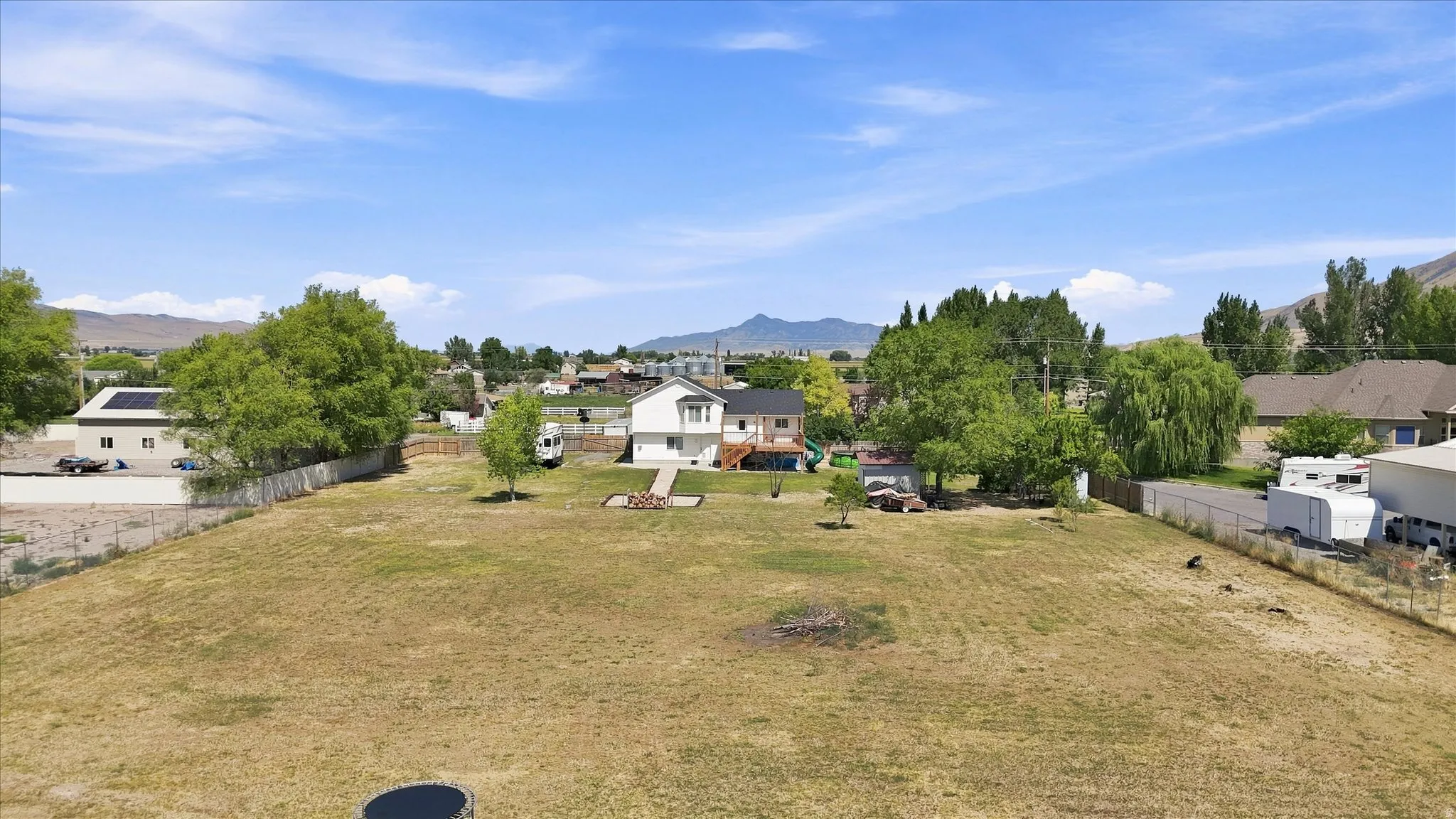 Expansive lot featuring mature trees and a fenced perimeter