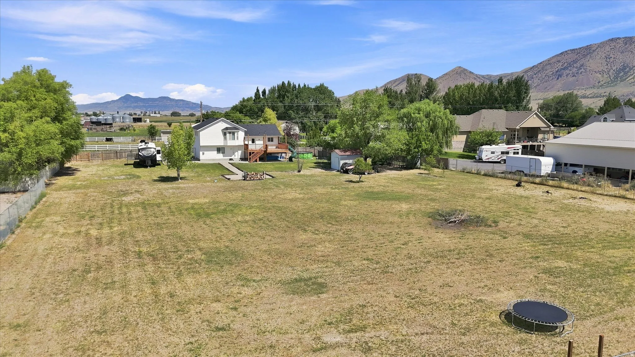 Expansive grassy area with mountain backdrop