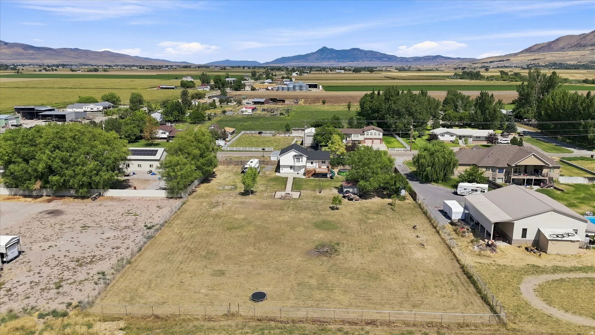 Expansive lot featuring a large grassy area and mature trees