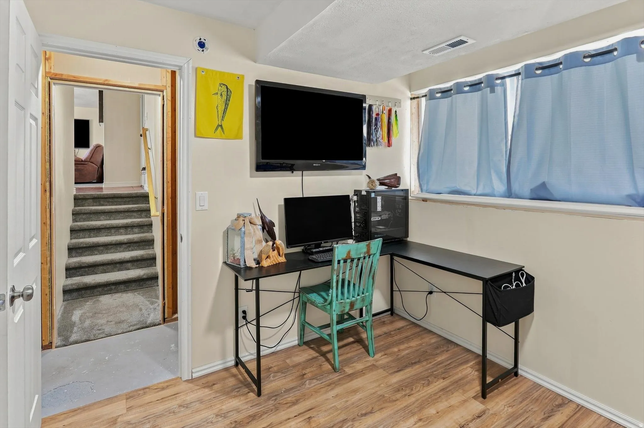 Wood-finish flooring with neutral wall tones and a window