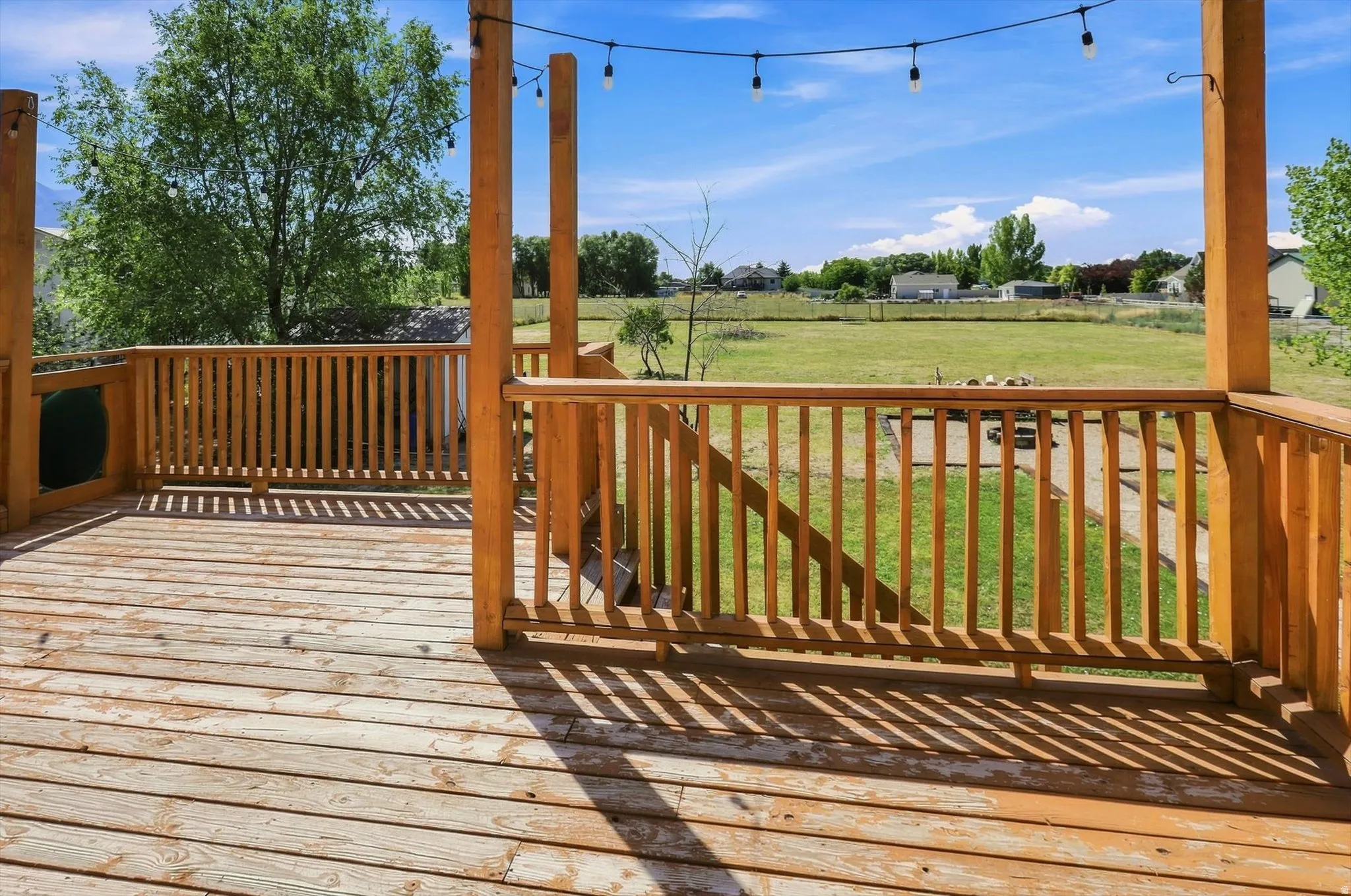 Wood deck with railing and string lights