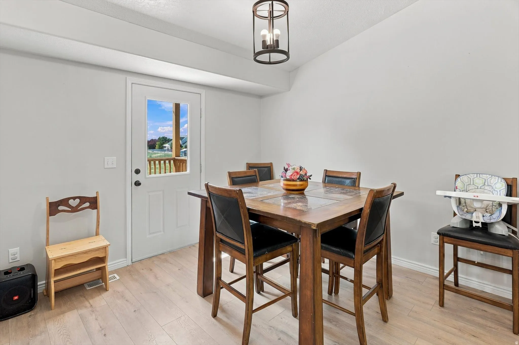 Wood-finish flooring, white walls, and a glass-paneled exterior door