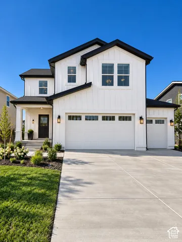 Modern farmhouse exterior with white board and batten siding, black trim, a two-car garage, an additional one-car garage, and a concrete driveway