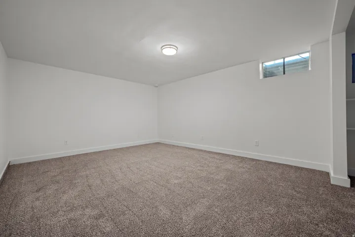 White interior walls with brown patterned carpet