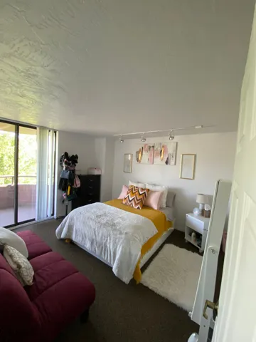 Wall-to-wall carpeting with a sliding glass door leading to an outdoor balcony