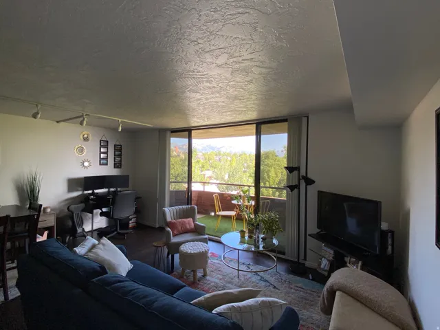 Full-height glass doors open to an outdoor balcony