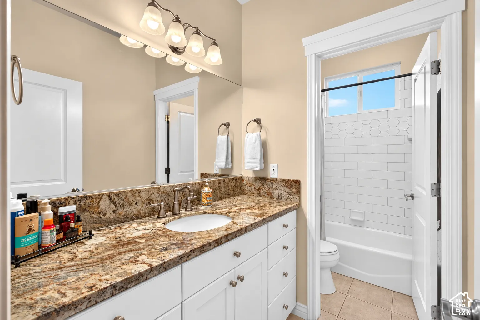 Double vanity with a granite countertop, undermount sink, and brushed nickel fixtures