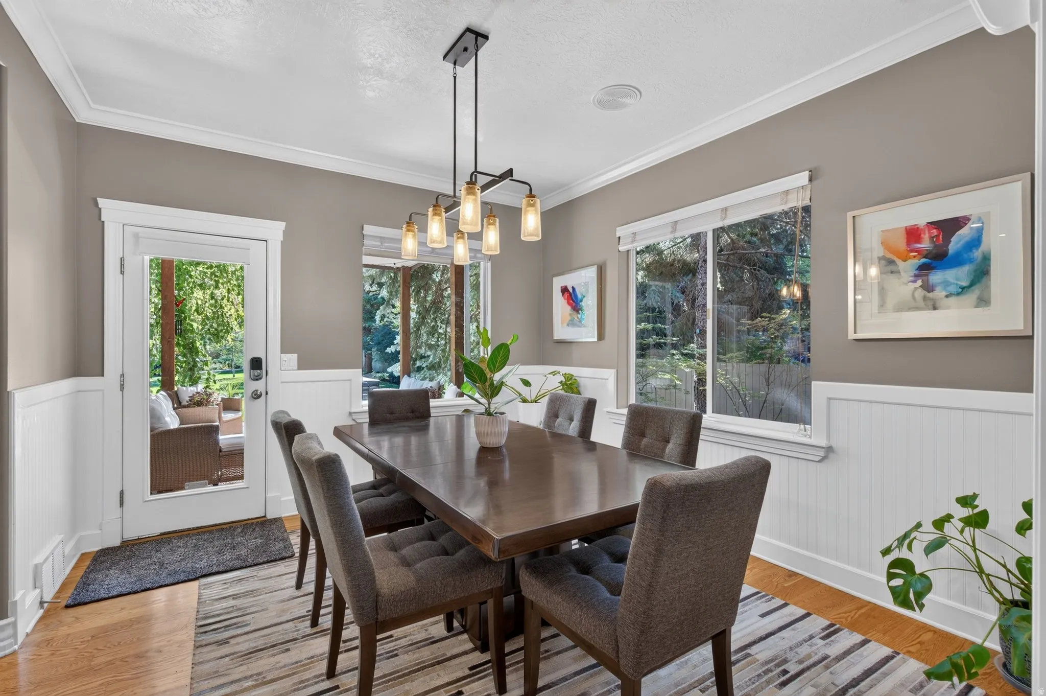 Hardwood flooring complemented by white wainscoting and a crisp crown molding detail