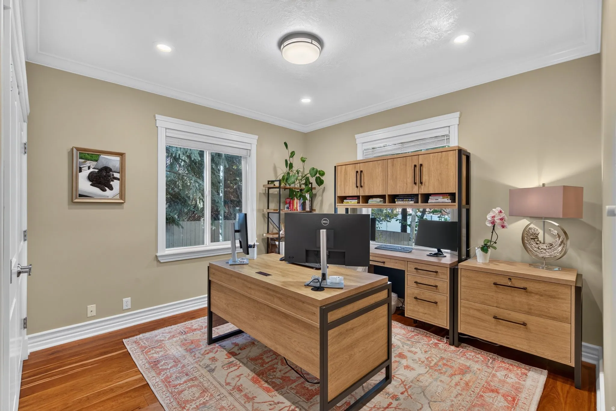 Recessed lighting, crown molding, wood-finish flooring, and white trim throughout