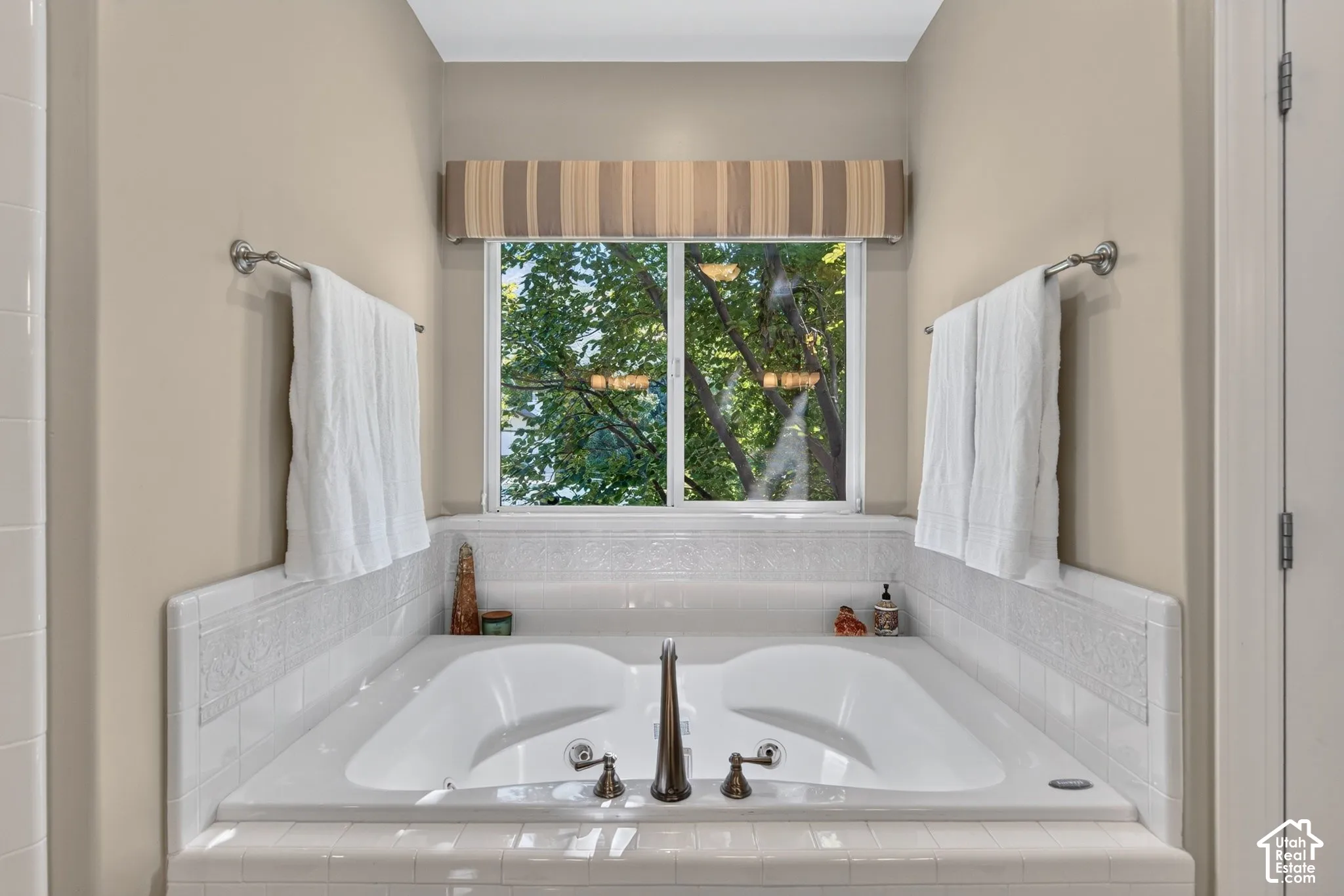 Luxurious dual-sink vanity with white quartz countertops, oil-rubbed bronze faucetry, and integrated white subway tile backsplash