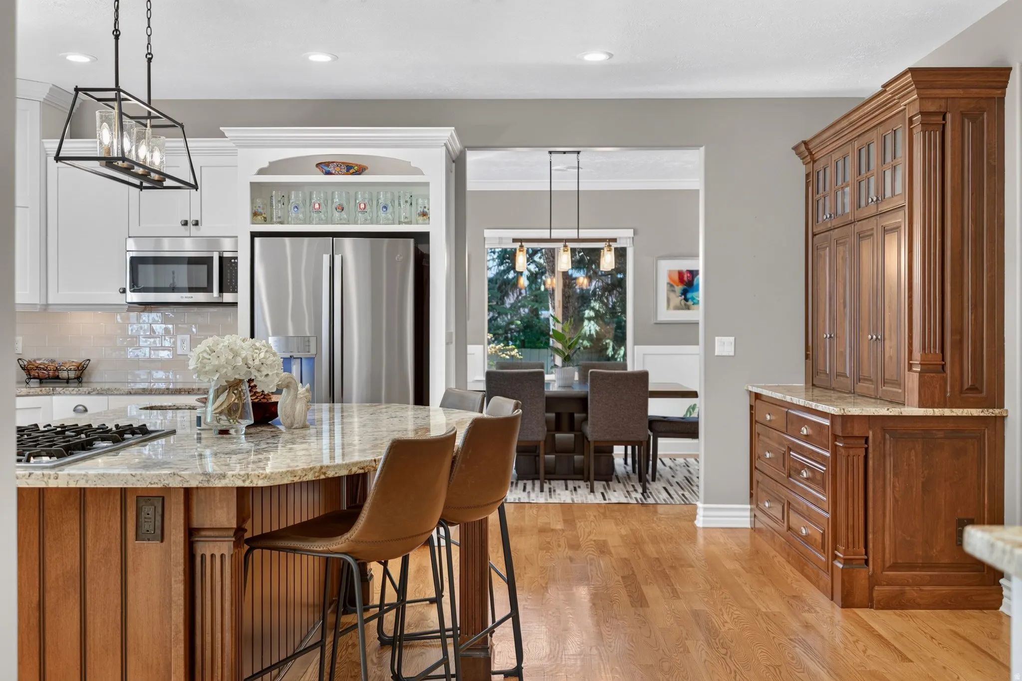Gourmet kitchen with granite countertops, stainless steel appliances, and wood-finish flooring