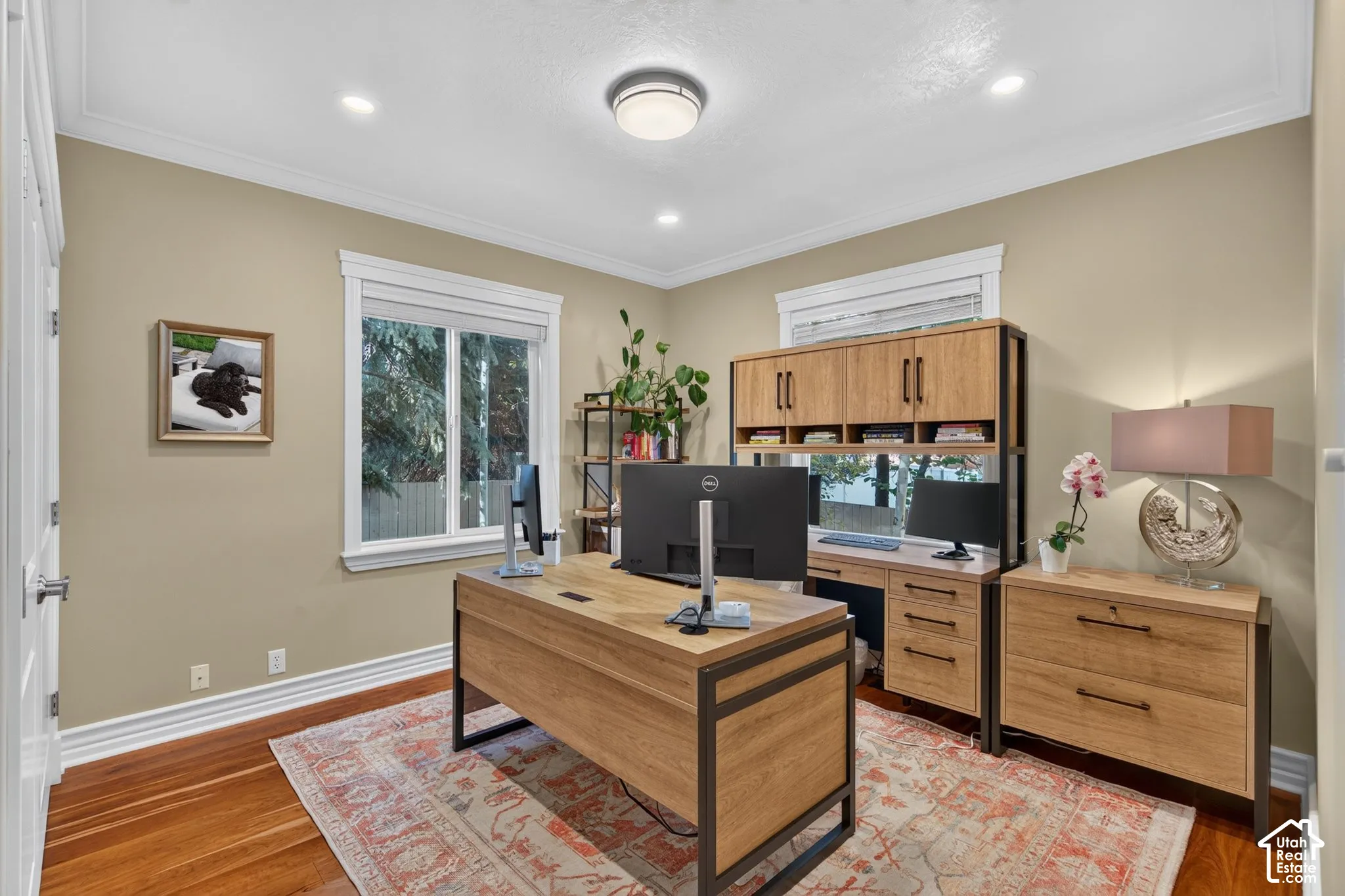 Recessed lighting, crown molding, wood-finish flooring, and white trim throughout
