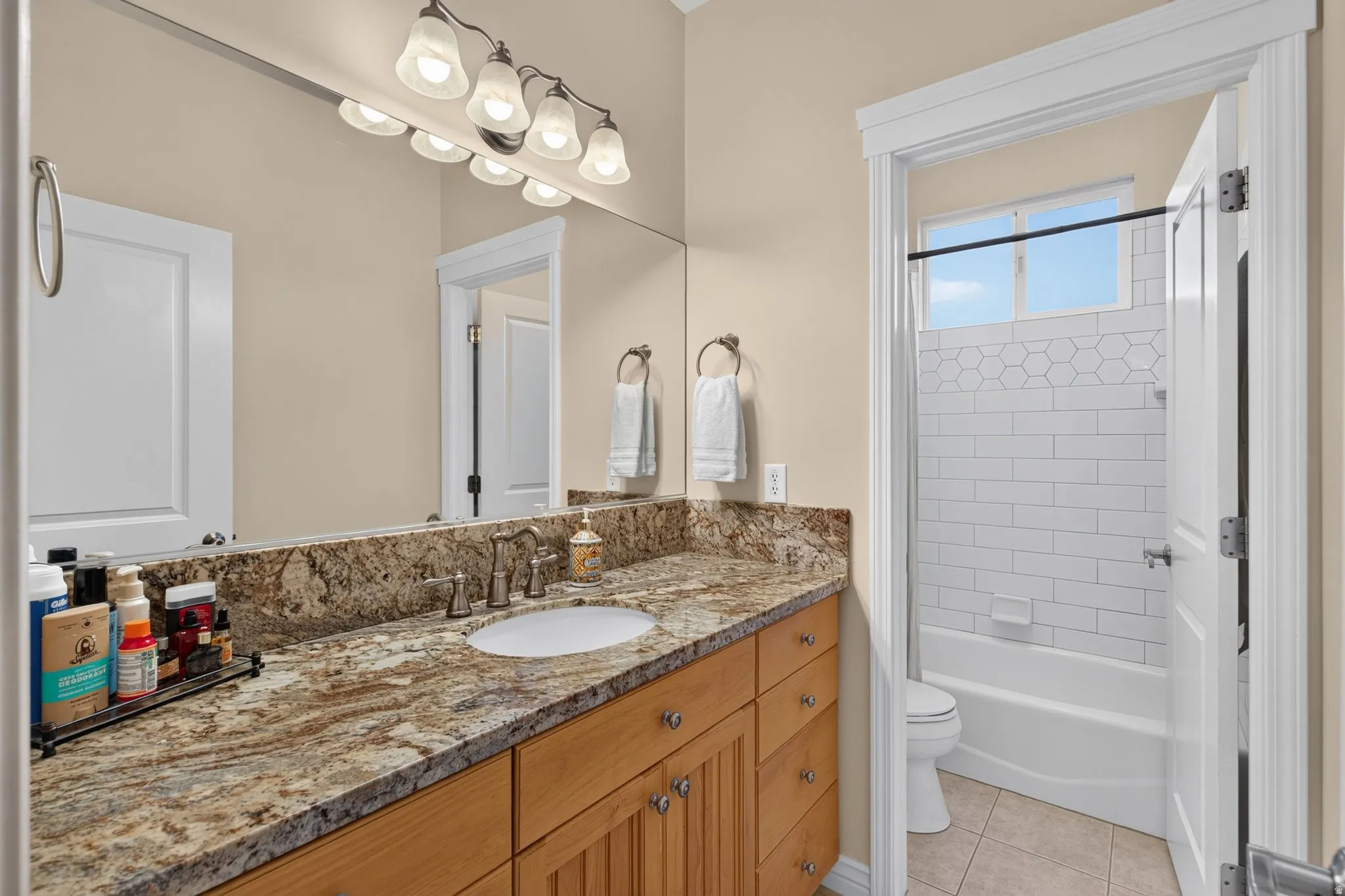Double vanity with granite countertop and wood cabinetry