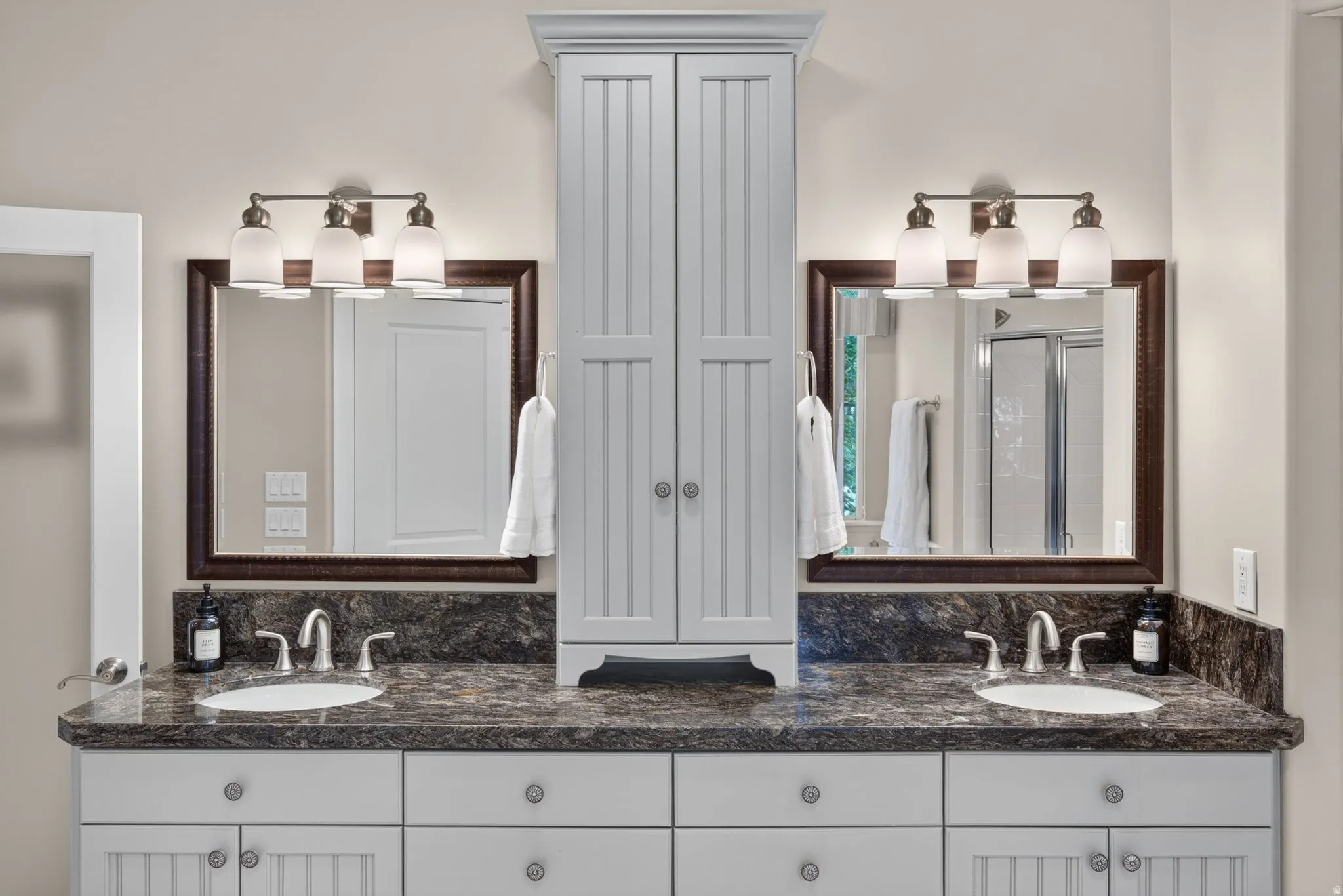 Dual vanity with undermount sinks, stone countertops, and brushed nickel fixtures