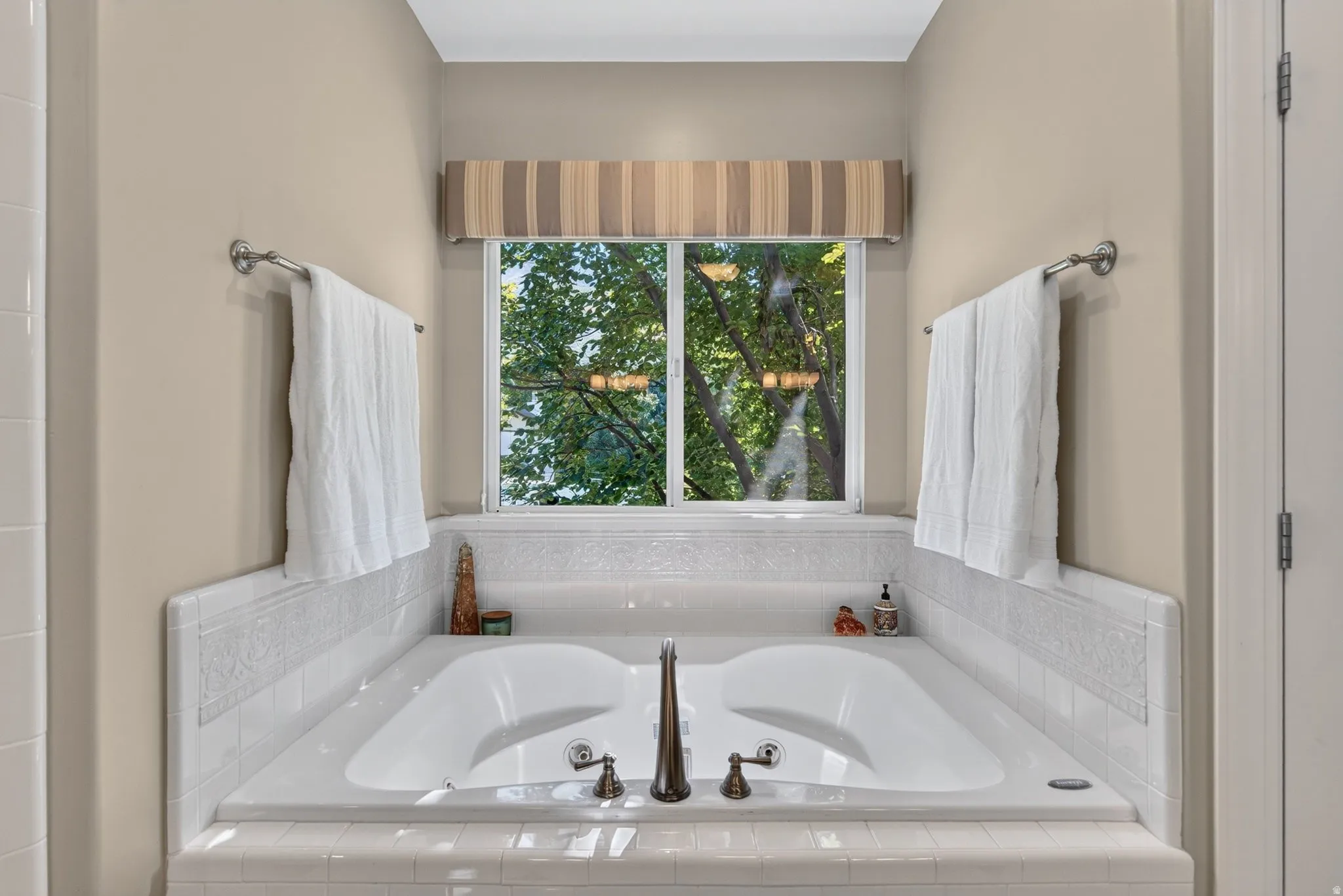 Luxurious dual-sink vanity with white quartz countertops, oil-rubbed bronze faucetry, and integrated white subway tile backsplash