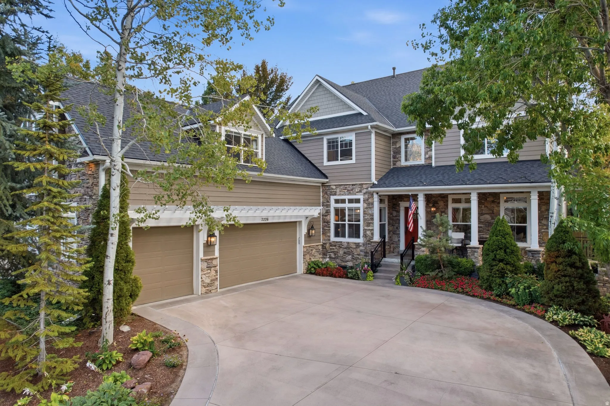 Stone and siding exterior with a covered porch