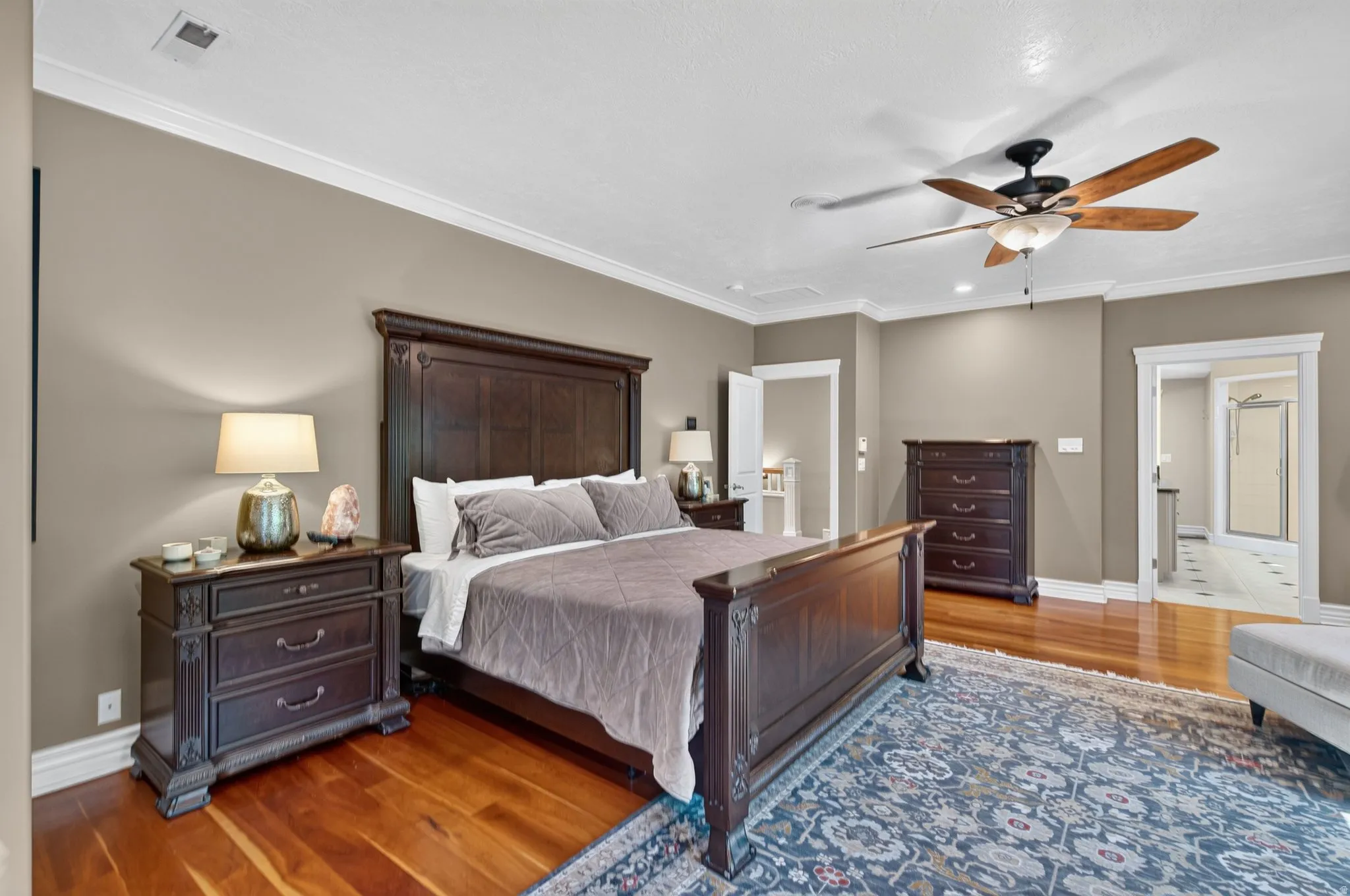 Hardwood flooring, crown molding, ceiling fan with integrated lighting, recessed lighting, and white trim