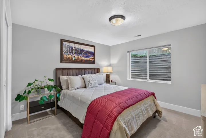 Light gray wall paint, white trim, recessed window, flush-mount ceiling light, and carpeted flooring