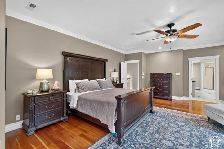 Hardwood flooring, crown molding, ceiling fan with integrated lighting, recessed lighting, and white trim