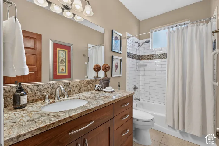 Spa-inspired bathroom featuring a granite-topped double vanity with wood cabinetry, polished nickel fixtures, and recessed lighting