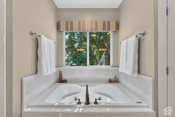 Luxurious dual-sink vanity with white quartz countertops, oil-rubbed bronze faucetry, and integrated white subway tile backsplash