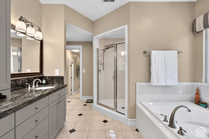 Double vanity with a dark countertop and integrated sink