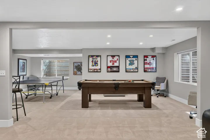 Recessed ceiling lighting, light neutral-toned carpeting, and a window with blinds