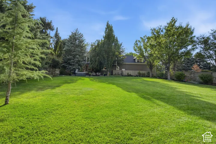 Expansive lawn area, mature trees, and a private rear exterior