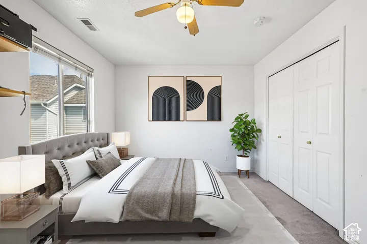 Wall-to-wall carpeting and a ceiling fan with integrated lighting