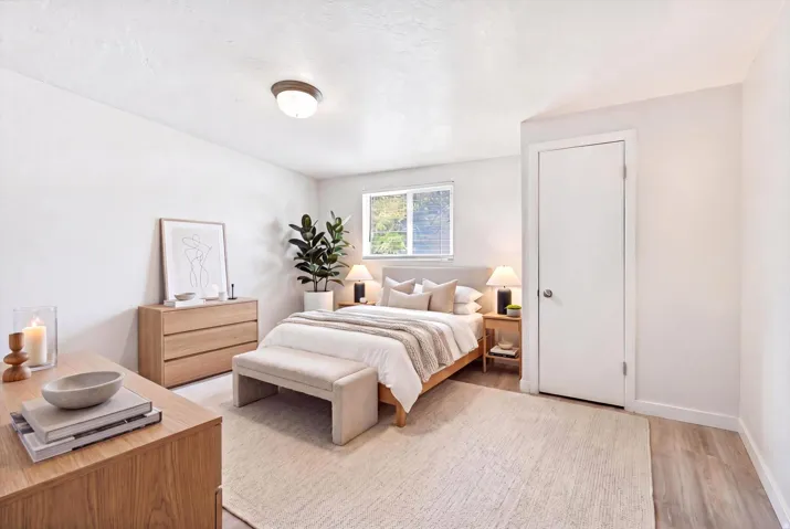 Window with natural lighting, light-toned wood-finish flooring, white walls, and a ceiling-mounted light fixture
