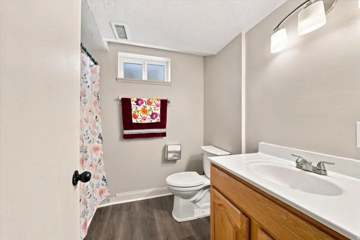 Light and bright updated basement bathroom .