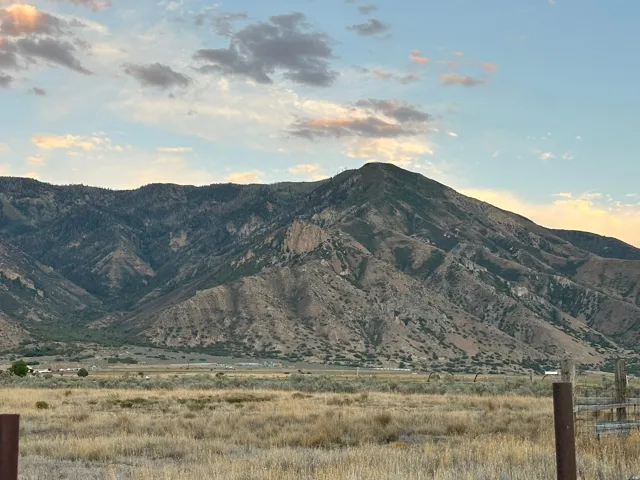 Mountain backdrop with natural terrain and distant structures