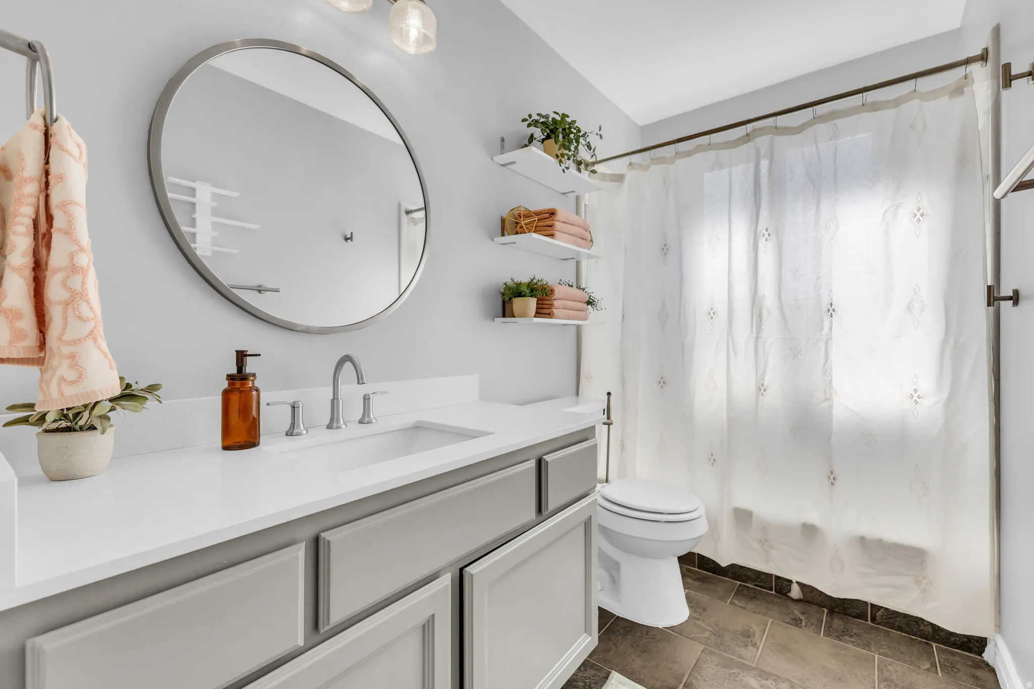 Vanity with white countertop, undermount sink, and brushed nickel faucet